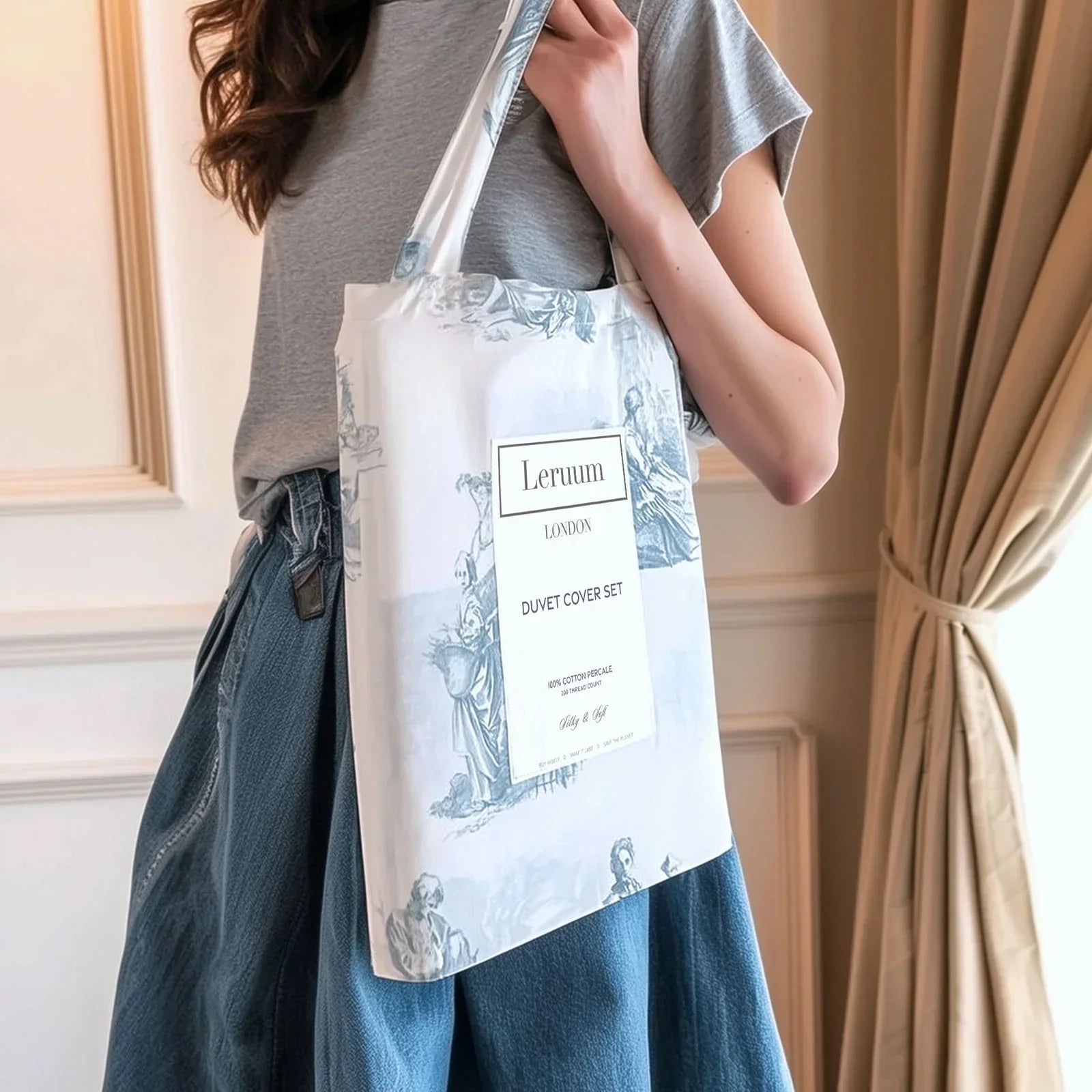 Woman holding Leruum London blue and white toile de Jouy duvet cover set bag